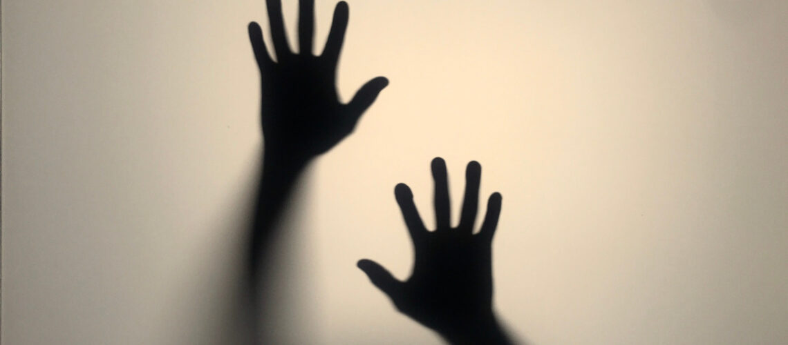 Shadow of two hands on a white screen